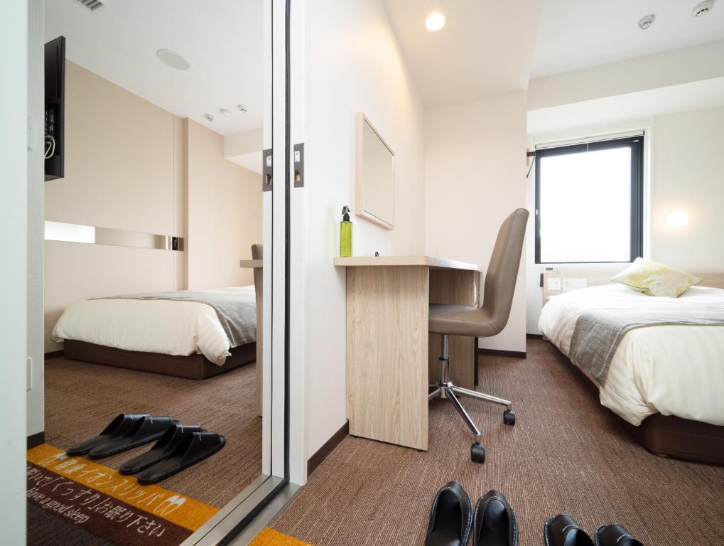 Postel nebo postele na pokoji v ubytování Super Hotel Tokyo Hamamatsucho