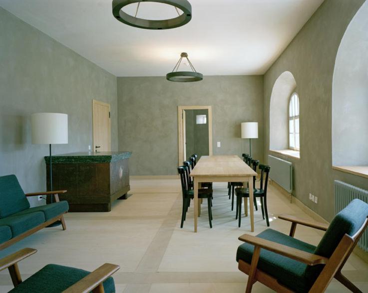 a living room with a table and chairs at Ospizio San Gottardo in Airolo