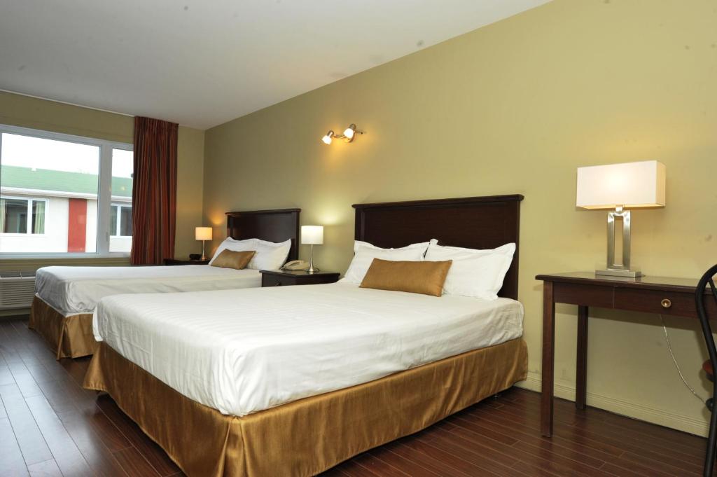 Postel nebo postele na pokoji v ubytování Hotel Le Voyageur
