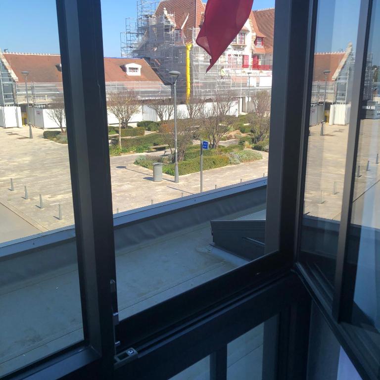 an open window with a view of a street at Amirauté in La Baule