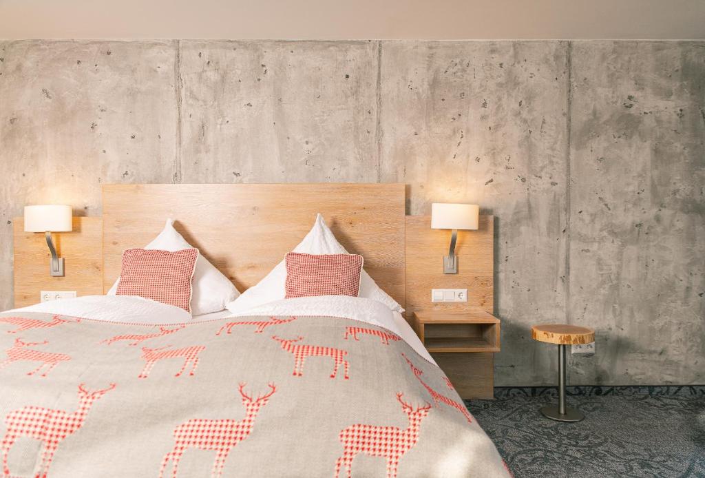 SallneckにあるGenusshotel Hirschen - Erholung im Grünen (Südschwarzwald)のベッドルーム1室(大型ベッド1台、ランプ2つ付)