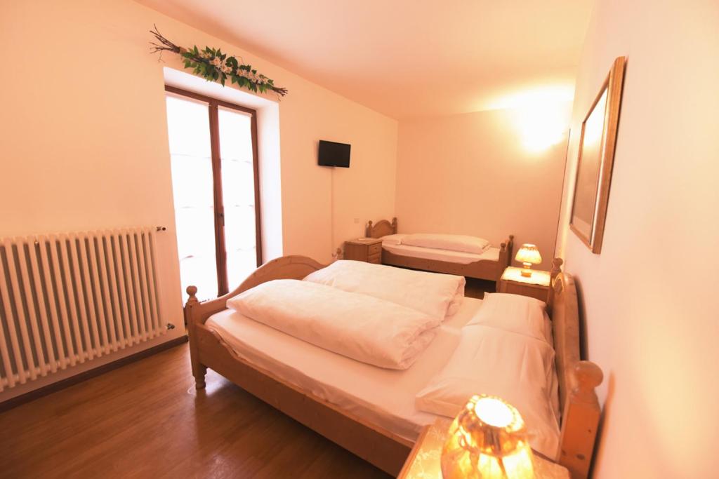 Postel nebo postele na pokoji v ubytování Agriturismo Salizzoni