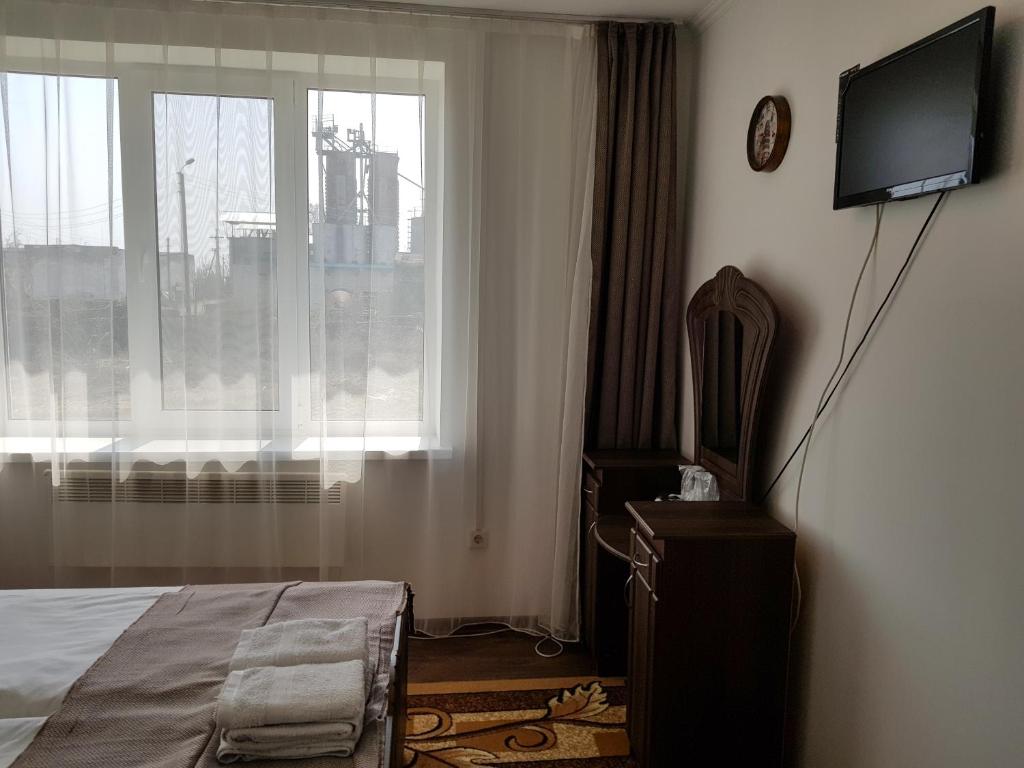 TV a/nebo společenská místnost v ubytování Adina