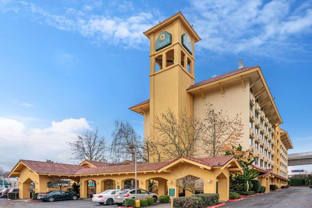 a large building with a clock on the top of it at La Quinta by Wyndham Seattle Sea-Tac Airport in SeaTac