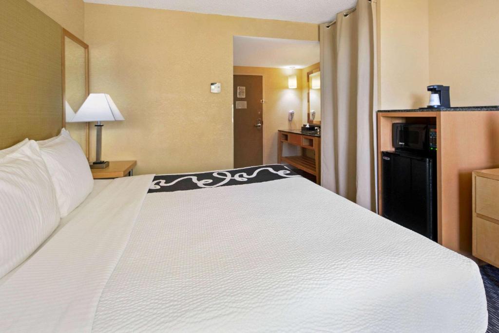 a large white bed in a hotel room at La Quinta Inn & Suites by Wyndham Sunrise in Sunrise