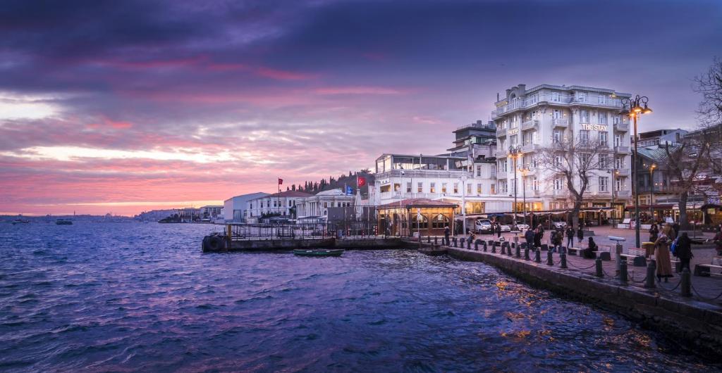 a building next to a body of water at dusk at The Stay Bosphorus in Istanbul