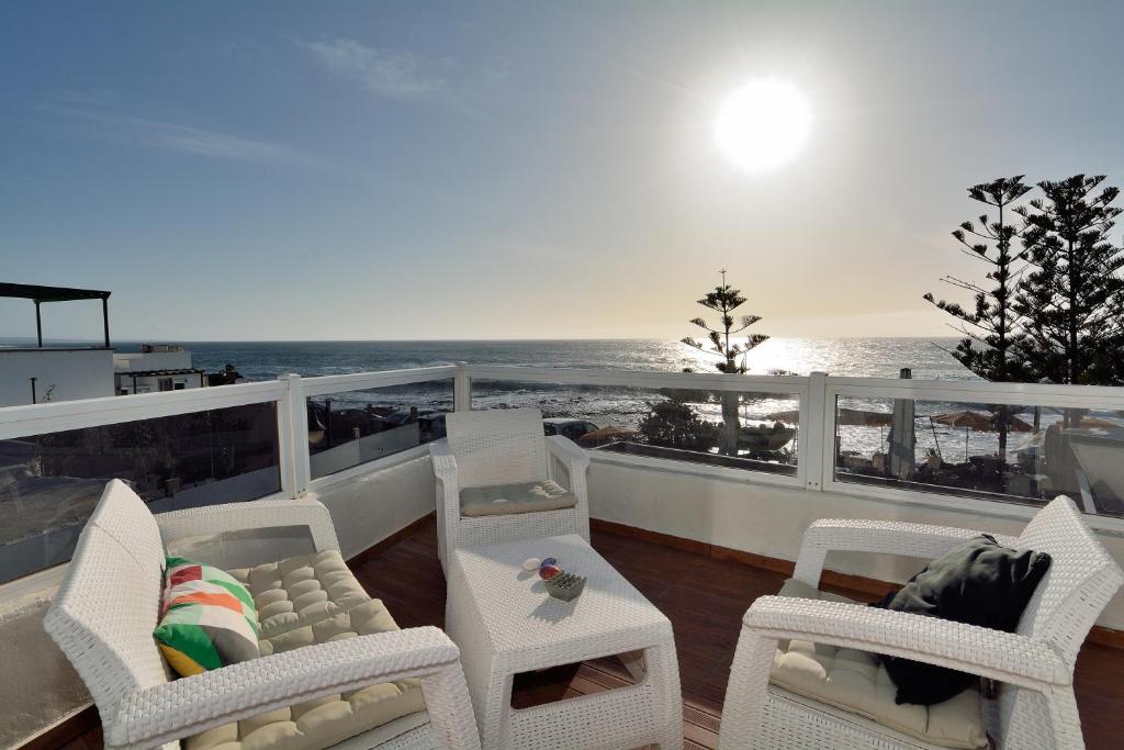 a balcony with chairs and a table and the ocean at Top Sea Views in El Golfo Prime location By PVL in El Golfo
