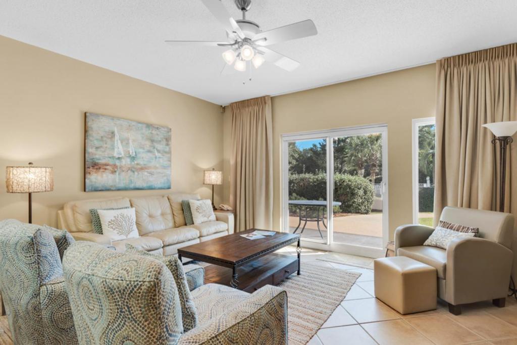 a living room with a couch and chairs and a table at Gulf View from the Summit at Tops'l Beach Resort in Destin