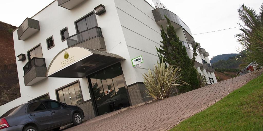 a car parked in front of a building at Imperial Hotel in Santa Bárbara