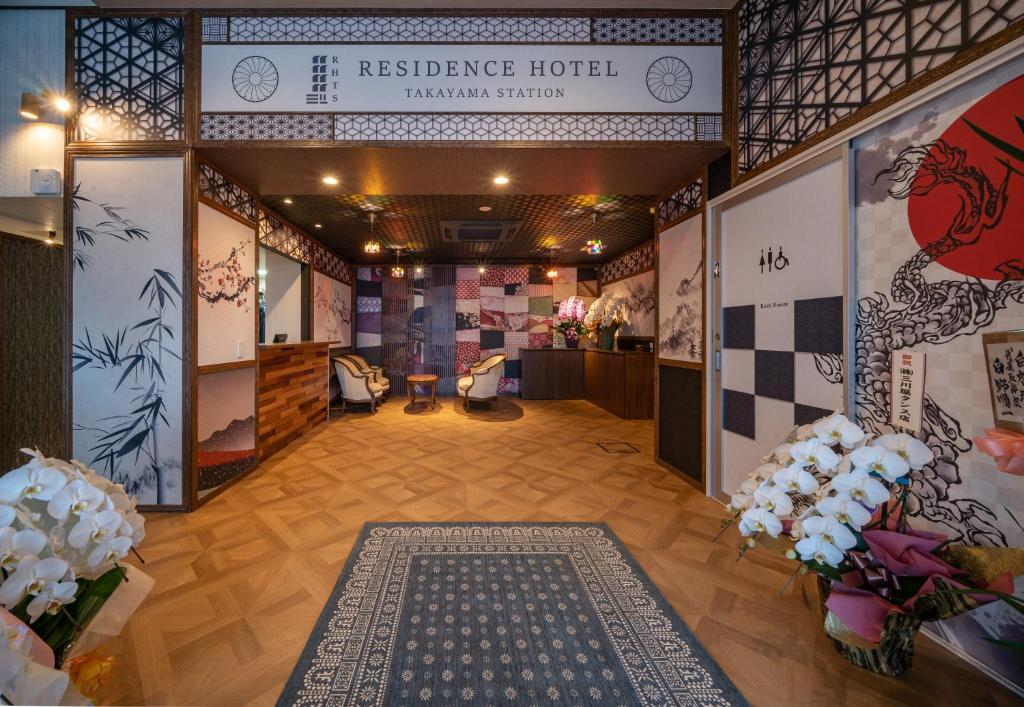 a living room filled with furniture and decorations at Residence Hotel Takayama Station in Takayama
