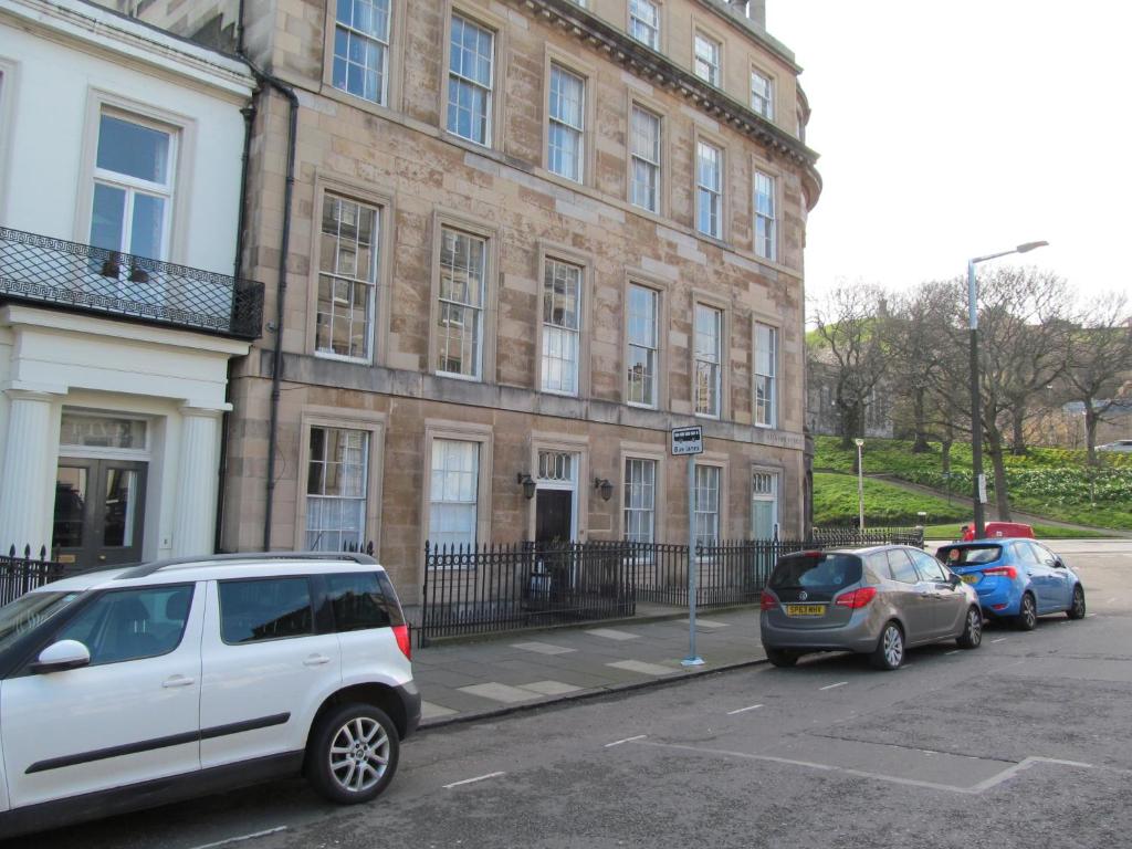 cars parked in front of a building at Lantern Guest House in Edinburgh