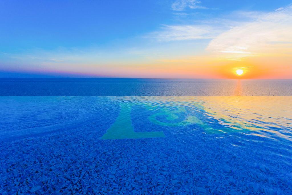 an arrow in the water with a sunset in the background at H Resort in Checheng