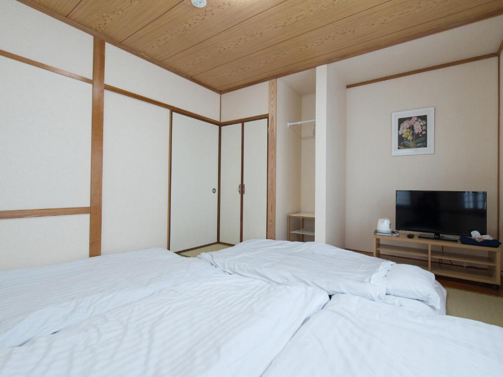 Postel nebo postele na pokoji v ubytování Tabist Hotel Aihama Beppu