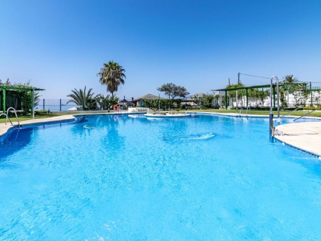 a large swimming pool with blue water at Apartamento 358 in Marbella
