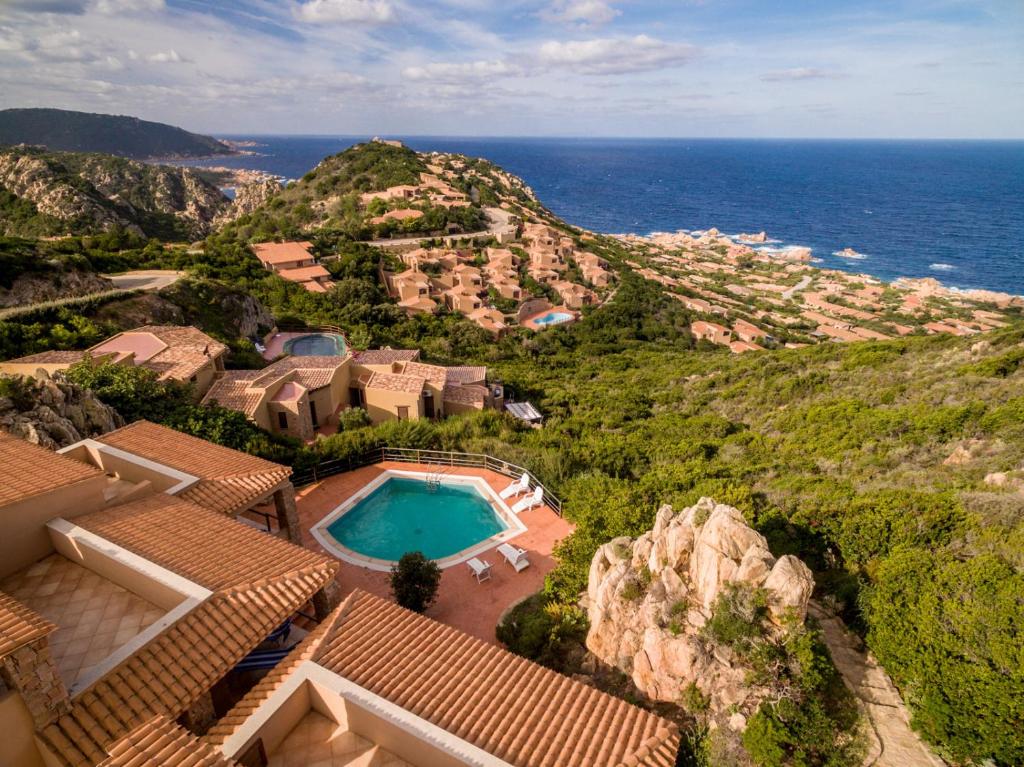 an aerial view of a house with a swimming pool and the ocean at Casa Rosa Arancio in Costa Paradiso