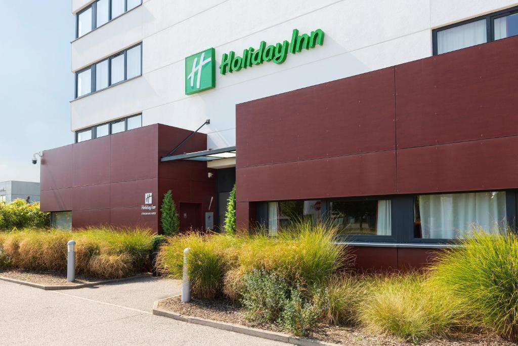 a building with a sign on the side of it at Holiday Inn - Strasbourg - Nord, an IHG Hotel in Schiltigheim