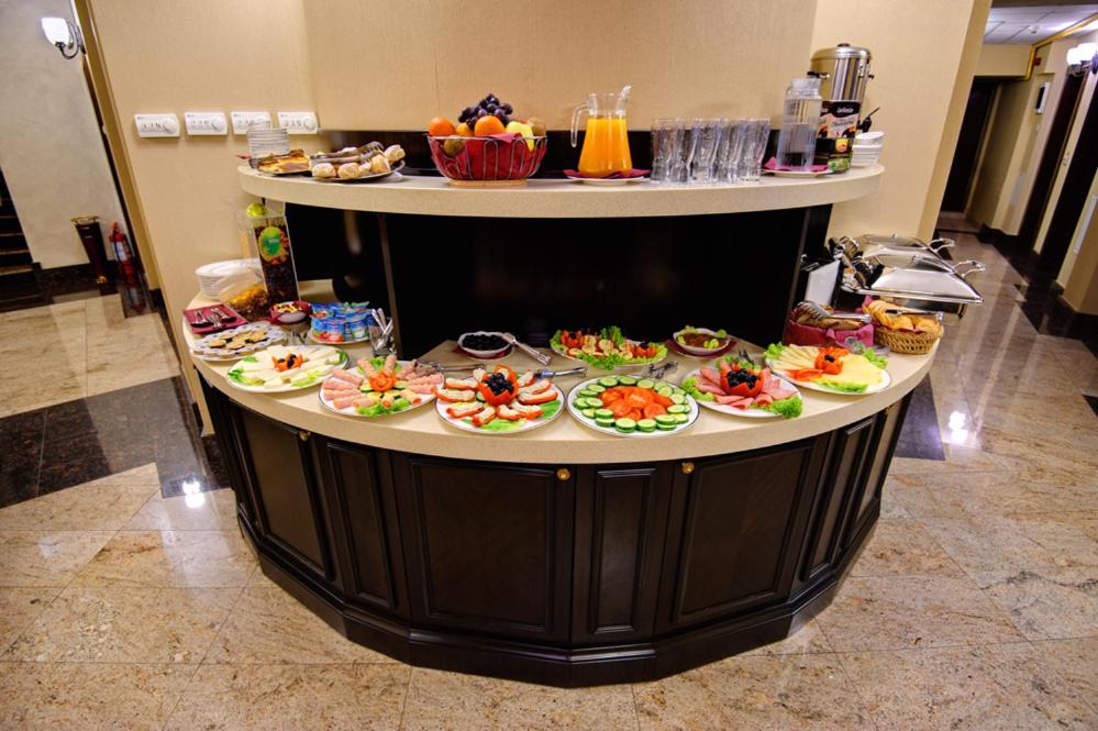 a table with plates of food on top at Hotel Carol in Constanţa