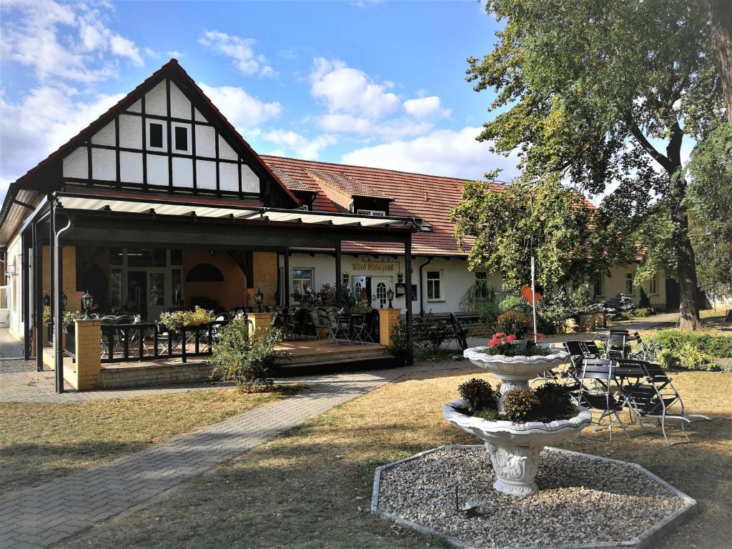 a building with a fountain in front of it at Hotel Altes Badehaus in Bad Dürrenberg