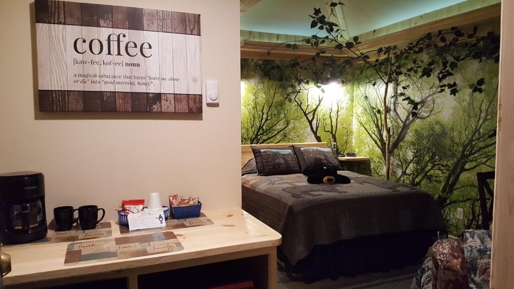 a room with a bed and a table with a sign at Bear Cove Inn in Saint Ignace
