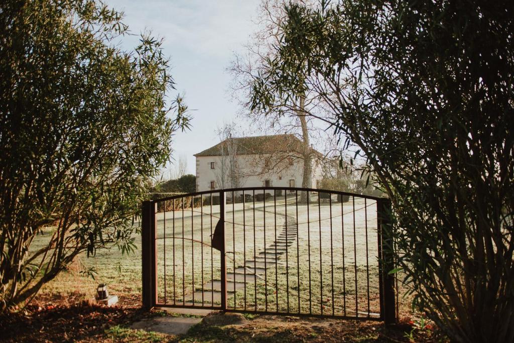 an old building behind a gate in a field at Cuna House in Armentera