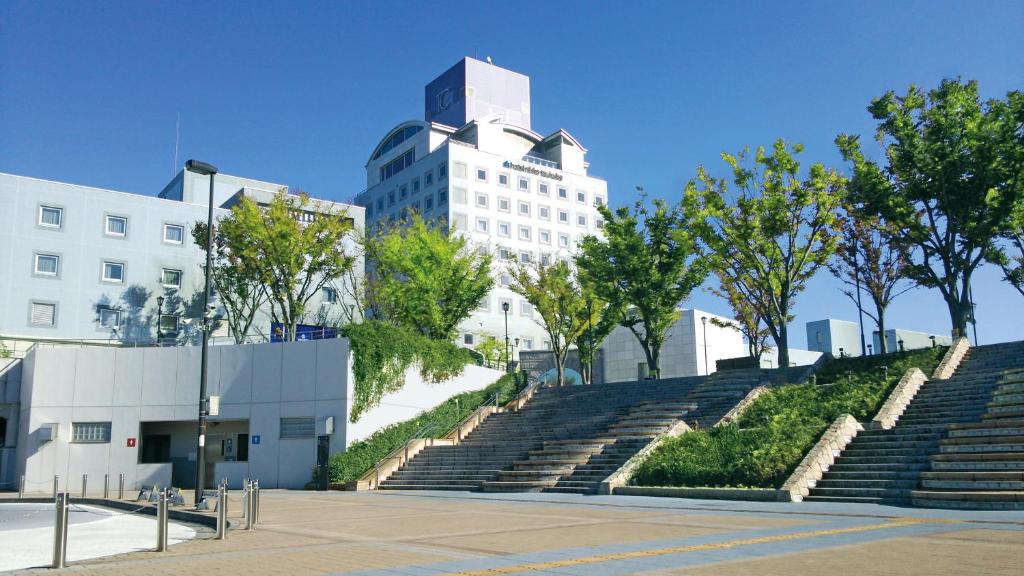 a set of stairs with a building in the background at Hotel Nikko Tsukuba in Tsukuba