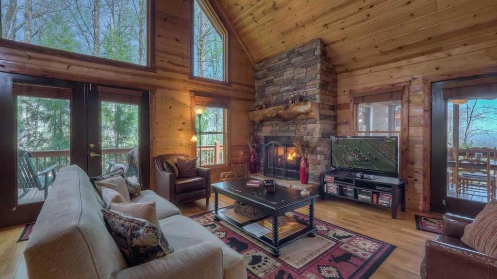a living room with a fireplace and a tv at Bent Tree in Blue Ridge
