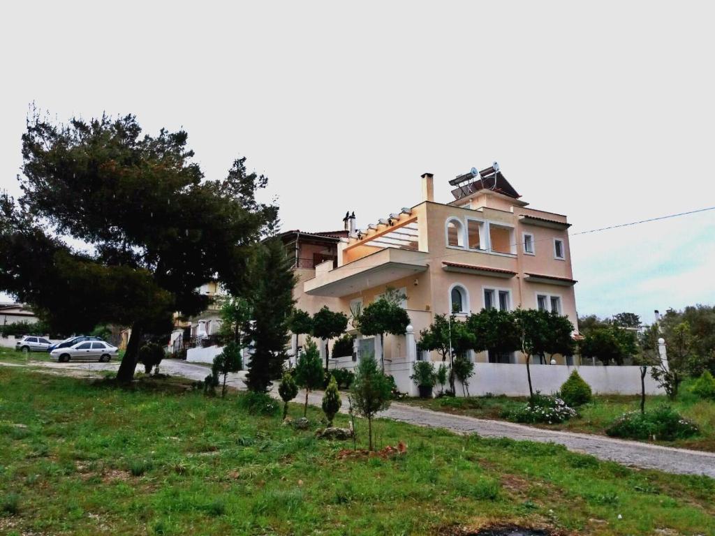 a large house with trees in front of it at HELEN in Artemida
