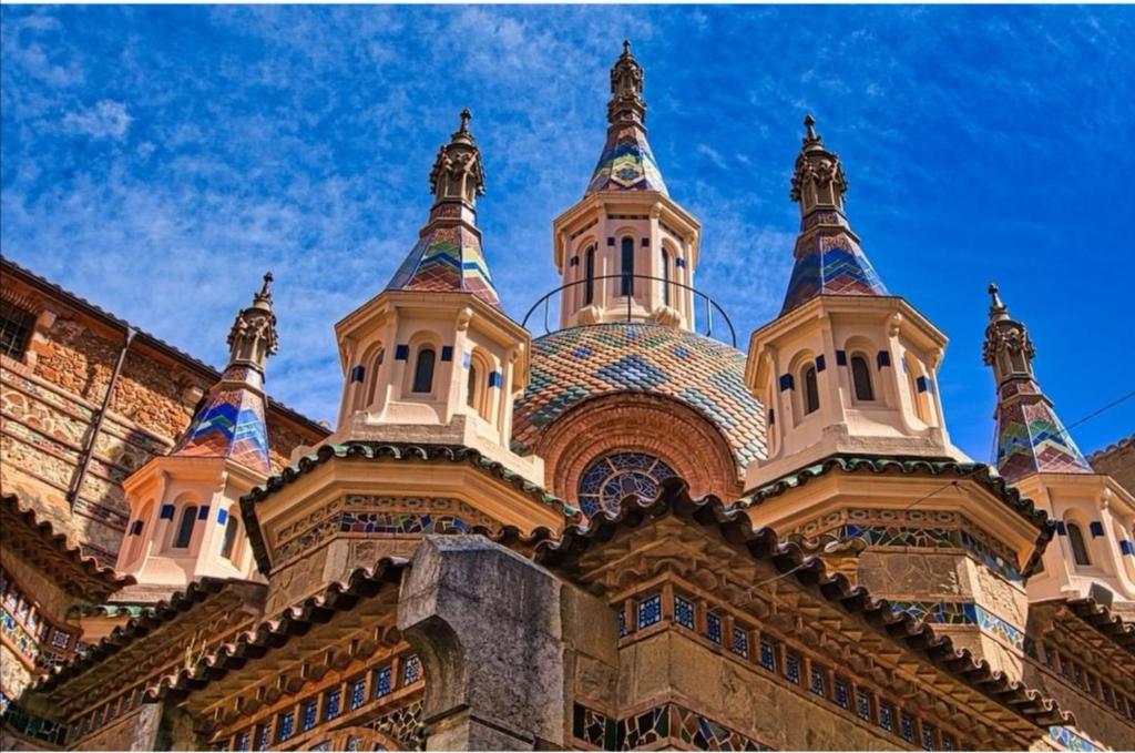 a building with turrets and domes on top of it at SeaHomes Vacations, BEACH&POOL, in Fenals Beach in Lloret de Mar