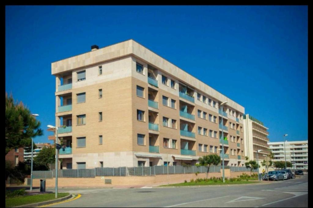 a large apartment building on the side of a street at SeaHomes Vacations, BEACH&POOL, in Fenals Beach in Lloret de Mar