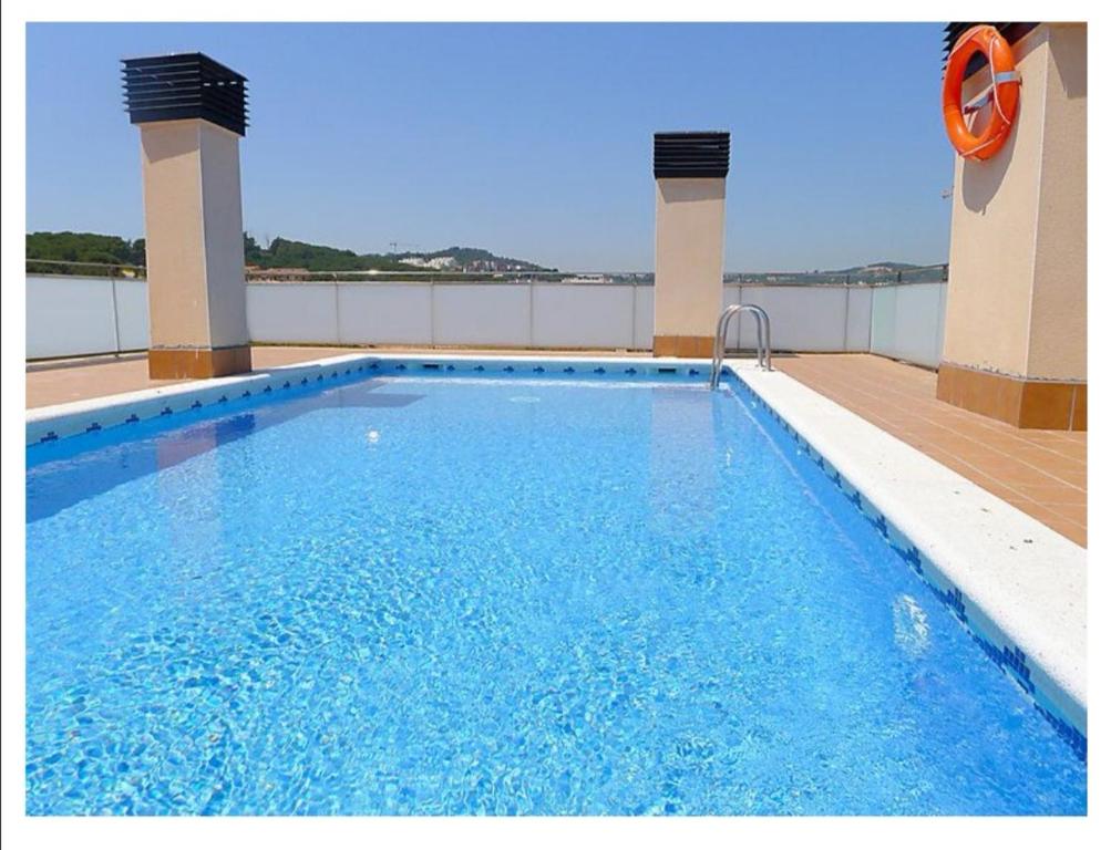 a swimming pool on the roof of a building at SeaHomes Vacations, BEACH&POOL, in Fenals Beach in Lloret de Mar