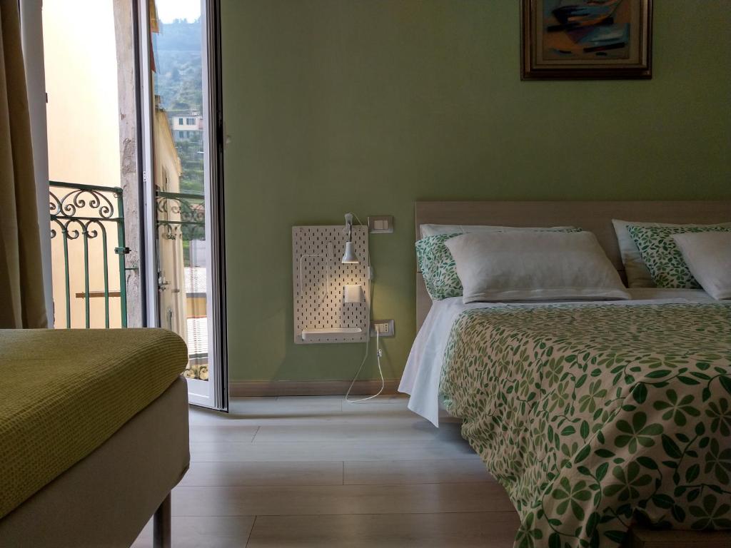 a bedroom with a bed and a balcony at AWroom in Riomaggiore