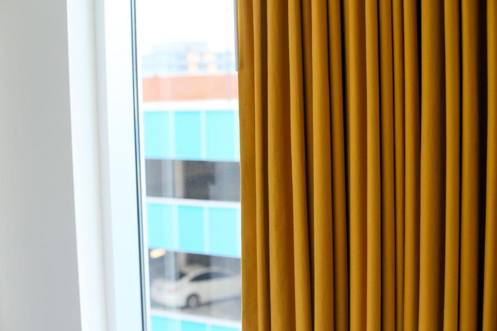 a yellow curtain in front of a window at The Durham Hotel in Durham
