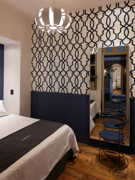 Postel nebo postele na pokoji v ubytování Carlota Sustainable Design Hotel