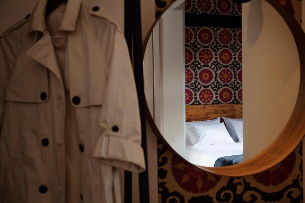 a bedroom with a mirror and a bed in a room at Carlota Sustainable Design Hotel in Quito