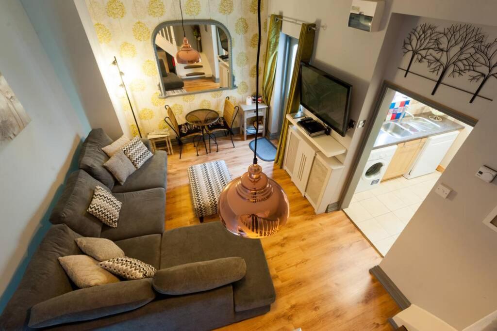 an overhead view of a living room with a couch and a television at Bakehouse in Harwich