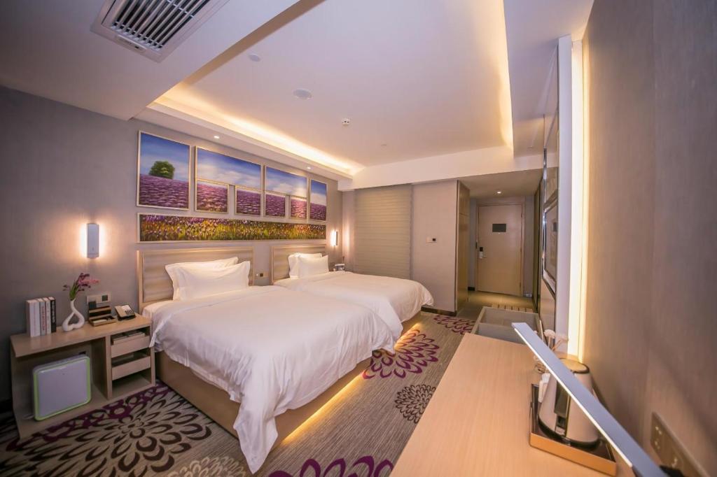 a large bedroom with a large white bed in it at Lavande Hotels·Sanya Pedestrian Street in Sanya