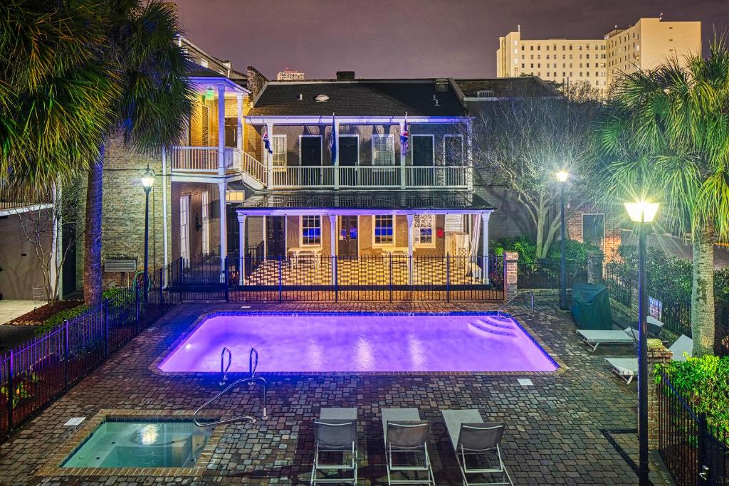 a house with a swimming pool in front of a house at Maison Saint Charles in New Orleans