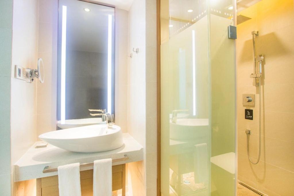 a white bathroom with a sink and a shower at Lavande Hotels·Shenzhen Baoan Xinan in Shenzhen
