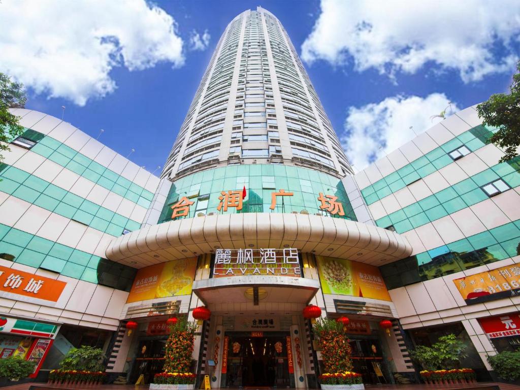 a tall building with a christmas tree in front of it at Lavande Hotels·Guangzhou Beijing Road Pedestrian Street Haizhu Square Metro Station in Guangzhou
