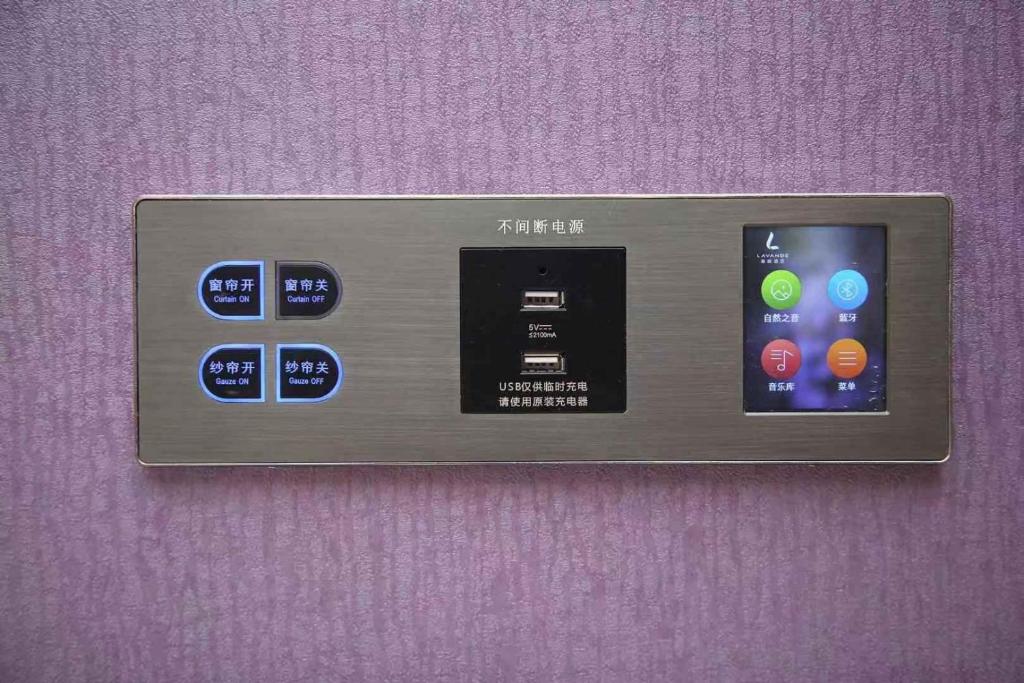 a remote control attached to a purple wall at Lavande Hotel Beijing Railway Station in Beijing