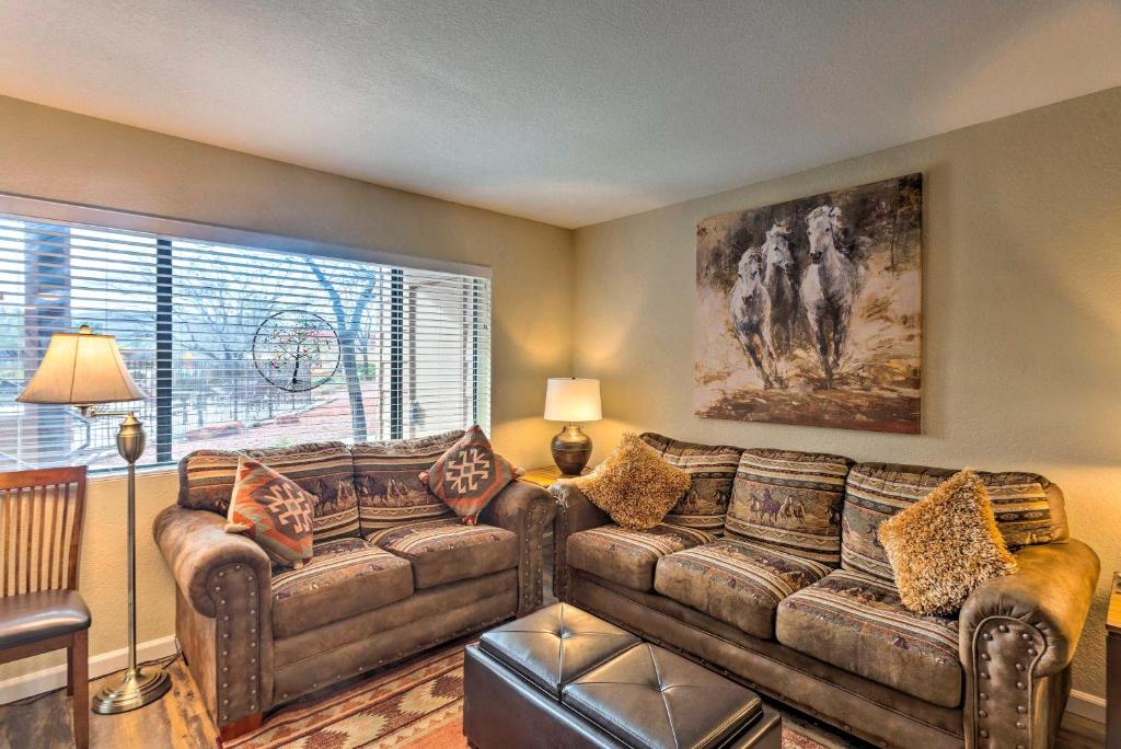 a living room with a couch and a large window at The Painted Pony Condo with Pool and Gym Access! in Sedona