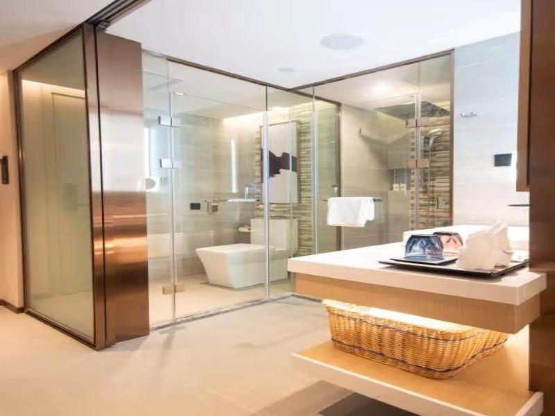 a bathroom with a glass shower and a sink at Lavande Hotels·Chongqing Monument for Liberation Haochi Street in Chongqing