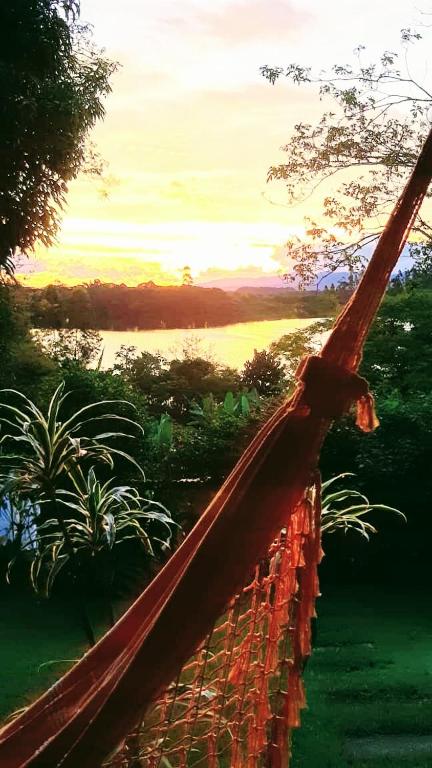 a painting of a fence with a view of a lake at Pousada Chácara Maria da Graça in Tremembé