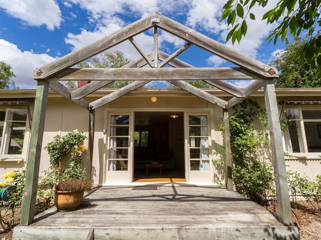 a house with awning and a porch at Arrow Bach - Arrowtown Holiday Home in Arrowtown