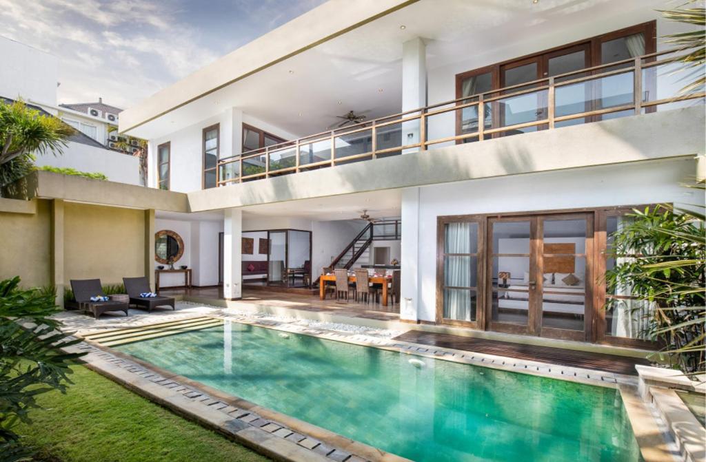 an exterior view of a house with a swimming pool at Danoya Private Luxury Residences in Seminyak