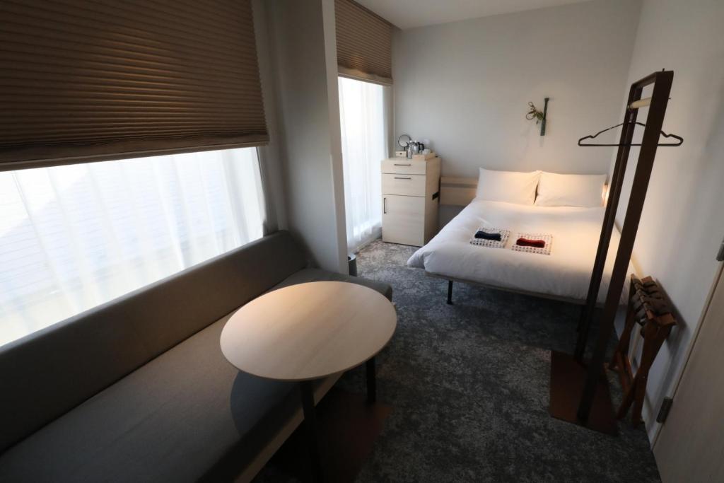 Postel nebo postele na pokoji v ubytování GEN HOTEL KAMAKURA