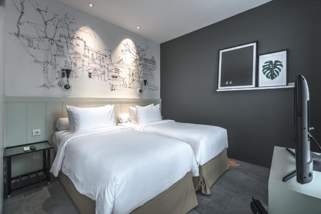 Ein Bett oder Betten in einem Zimmer der Unterkunft HARRIS Hotel & Conventions Malang
