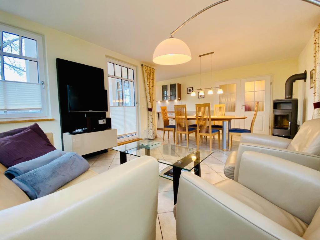 a living room with two white couches and a table at Neue Villa Ernst - Ferienwohnung 4 in Bansin