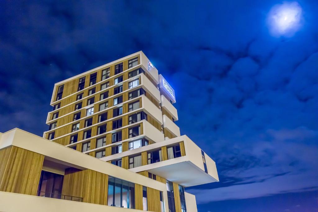 a hotel building with the moon in the sky at Van Der Valk Luxembourg Arlon in Arlon