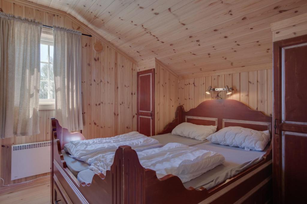 Postel nebo postele na pokoji v ubytování Mugnablikk
